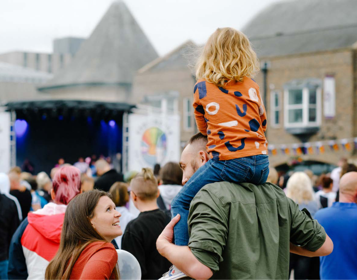 Child on parent's shoulders at an event in Tees Valley