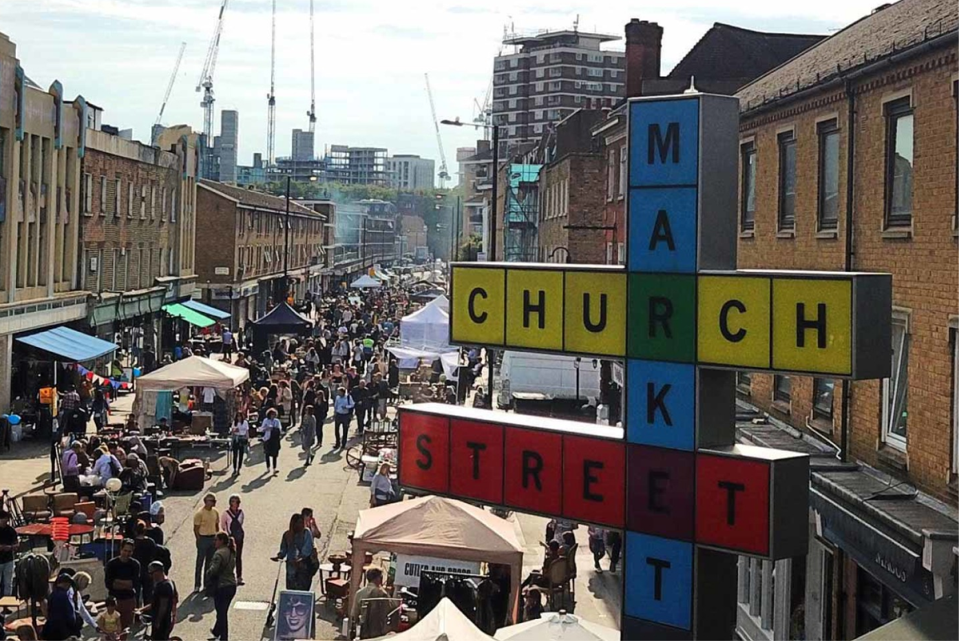 A bustling London market with a sign saying "Church Street Market"