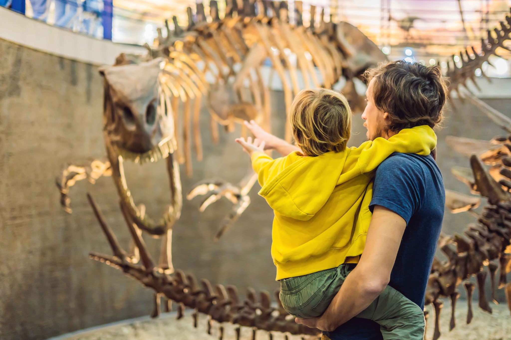 Dad and boy looking at dinosaur